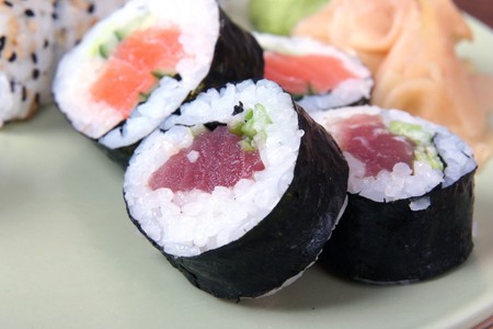 close up of sushi laying on green plate の写真素材