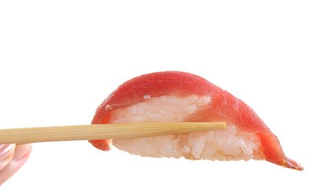 Wooden chopsticks holding sashimi isolated on white backgroundの写真素材