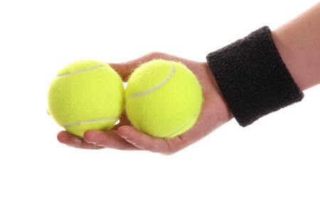 Hand holding tennis ball isolated on whiteの写真素材