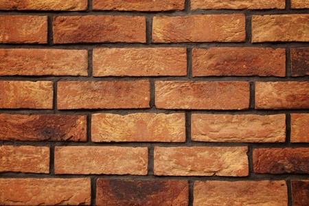 A brick old wall made of red and yellow bricks