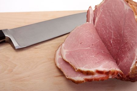  delicious, sliced  ham on a board with knife