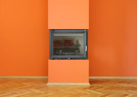  fireplace on orange wallの写真素材
