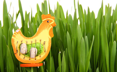 Easter decoration made with wooden hen and green grassの写真素材