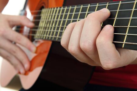 Acoustic guitar with hands.の写真素材