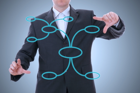 businessman drawing an organization chart on a gray backgroundの写真素材