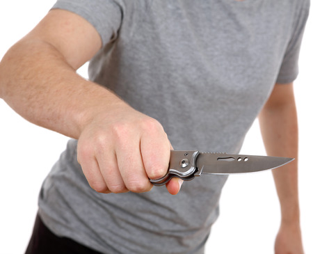 young man holding knife isolated on white backgroundの写真素材