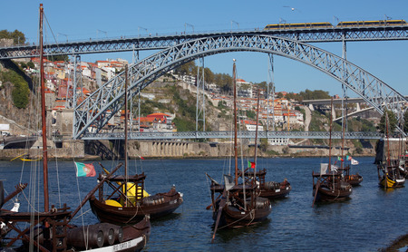 Porto,Portugal - old Portuguese boat on Douro river in front of the Dom Luis I bridge.の写真素材
