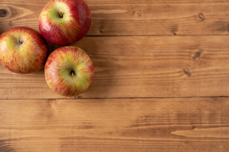 Red apples on wooden table