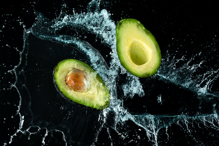 Avocado Water Splash on black backgroundの写真素材