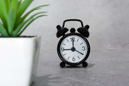 Black alarm clock isolated. The clock set at 9 oclock. Deadline concept.の写真素材