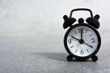 Black alarm clock isolated. The clock set at 10 oclock. Deadline concept.の写真素材