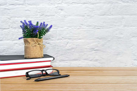 Office desk with supplies and wooden background. Copy space. Workspace concept.の写真素材