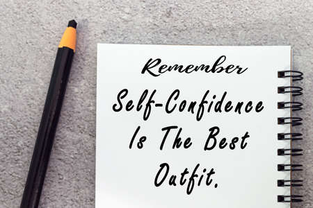Motivational quote on notepad - Remember self confidence is the best outfit.