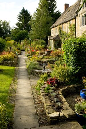 A typical English cottage garden in the Cotswolds, United Kingdom.の写真素材