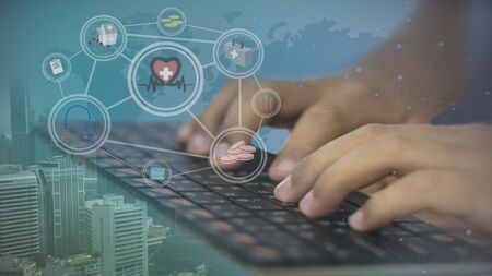 Hands on keyboard with the medical device icon on the world map