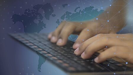 Hands that touch the keyboard with a data link Society on the mapの写真素材