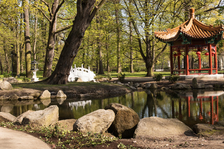 Poland.Warsaw.Chinese Garden in Lazienki(Bath)Royal Park.Horizontal view of the pond, bridge and pavilion.Photo was taken in April 2015のeditorial素材