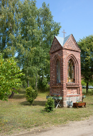 Poland in summer.Pomerania.Roadside chapel in the countryside.Very often found in rural areas sacral building.Vertical viewの写真素材