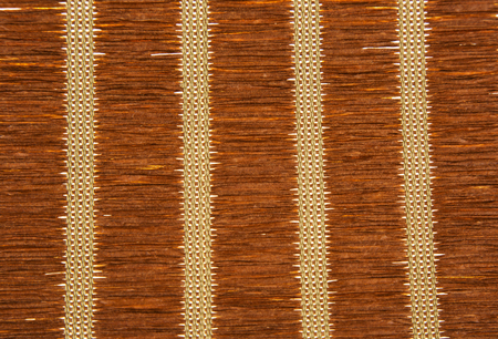 Straw mat in brown with vertical patterns in the shape of vertical white stripes.Very clearly visible texture and patternの写真素材