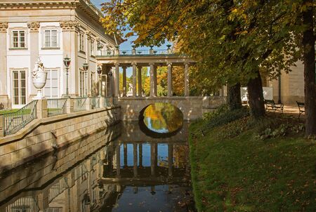 Poland.Warsaw.Poland.Lazienki Royal park in autumn.Palace on the water.View on the palace, canal and bridge with reflections in the water.Horizontal view.の写真素材