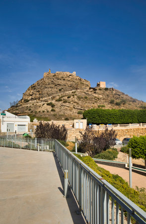View from the alley to the hill with the ruins of Busot Castle.Horizontal view.Spain, Alicante province.Vertical view.の写真素材