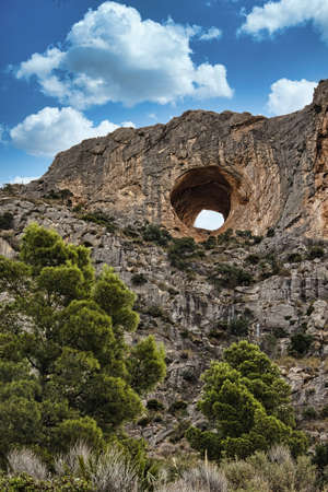 Spain, Alicante province.Cabeco D'or mountins The hole known as El Pet de la Reina, in Cresta de les...