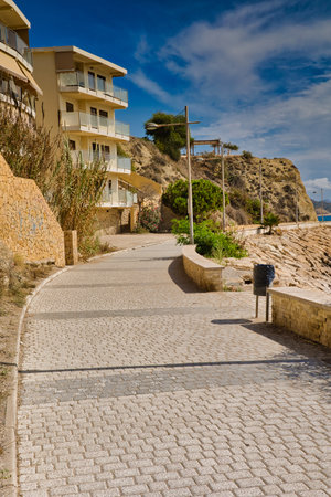 An avenue leading through residential estates to the top of the hill in the town of VillaYojosa, Spain. Alicante Province.Horizontal view.の写真素材