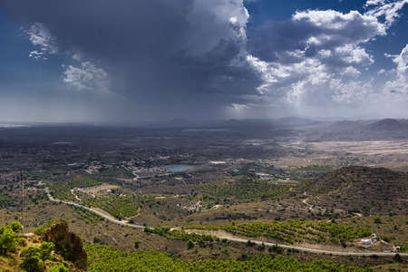 View of the valley near Busot. Heavy storm clouds gather in the sky. Horizonta view from top. Spain, province Alicanteの写真素材