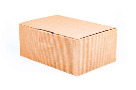 Simple single small brown corrugated cardboard delivery carton box with a lid closed isolated on...
