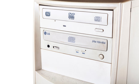 Cracow, MaÅopolska / Poland - circa January 2019: CD, DVD double optical disc drive bay on an old white pc computer case, midi tower disc reader detail, closeup. LG CD/DVD-ROM computer drive up closeのeditorial素材