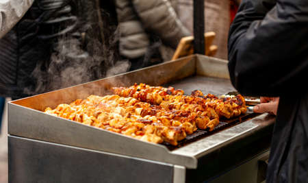 Man grilling a smoking hot delicious meat closeup, white steam visible. Outdoor grill, bbq, tasty...
