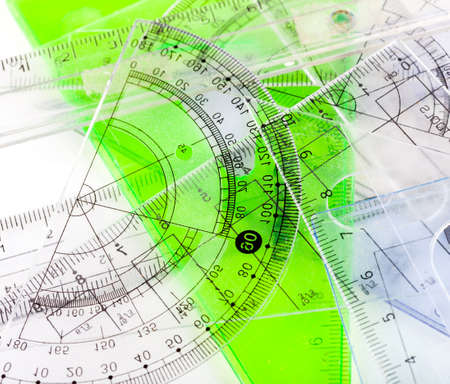 Lots of set squares, rulers, a protractor, various different plastic transparent school supplies set on a table, top view, abstract background texture. Mathematics, geometry, math education conceptの写真素材