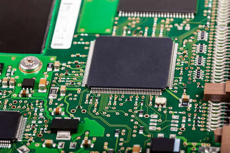 Complex electronics, green circuit board with a microcontroller, microprocessor control chip in the...