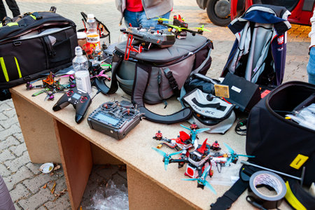 Cracow, MaÅopolska / Poland - circa October 2019: Drone race equipment, drones, remote controllers and batteries, bags and different accessories laying on the table at AGH drone racing eventのeditorial素材