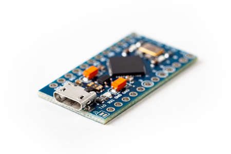 Simple small tiny microcontroller blue board macro extreme closeup, micro usb connection input hid human interface device programming electronics isolated on white, micro controller security conceptの写真素材