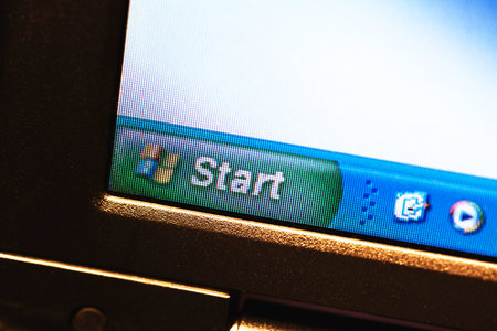 Windows XP start menu bar, windows logo on an old low resolution lcd display, closeup, pixels...