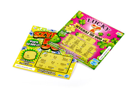 Two scratch off Polish lottery tickets. Gambling, winning money, two lottery paper coupons, tickets, scratchies, scratch cards isolated on whiteのeditorial素材