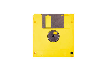 Single yellow floppy drive, old vintage diskette, asset isolated on white background, top view. Save icon concept, obsolete tech, data storing deviceの写真素材