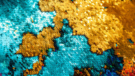 Shiny gold blue sequins background texture backdrop. Light stylish shining spangles pattern....