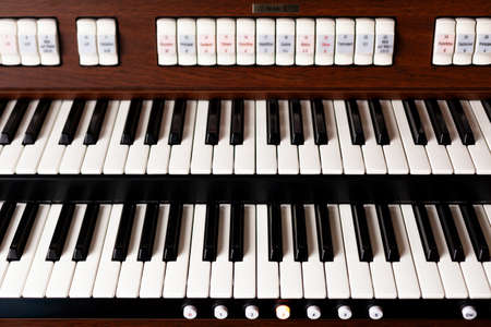 New modern pipe organ keyboards front view. Simple double electronic instrument keyboard seen from...
