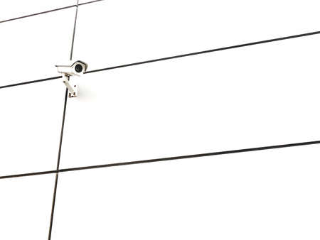 Single small surveillance camera on a perfectly white wall, sterile laboratory like environment....