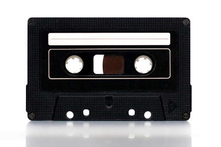 Old vintage black cassette with blank white label on white background. Text space.の写真素材