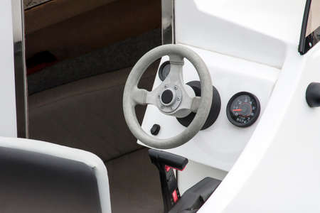 White clean new yacht, motorboat interior, steering wheel and captain's chair cockpit closeupの写真素材