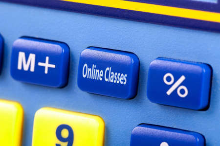 Online classes, text on calculator button, macro, extreme closeup. E-learning, covid 19 pandemic, coronavirus crisis education plan, educational system in quarantine simple abstract concept, nobodyの写真素材