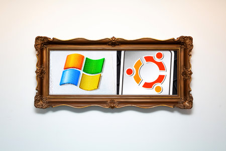 Windows vs Ubuntu abstract concept. Operating system logos in an old painting frame. OS choice, decisions, alternatives, dual boot conceptual, nobodyのeditorial素材
