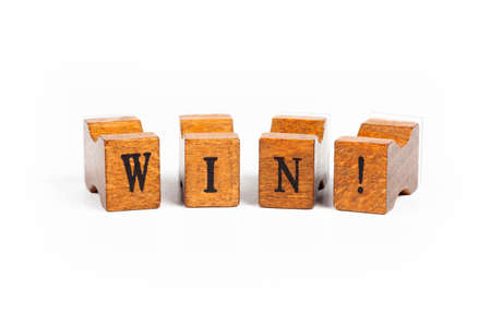 Word WIN! Small wooden moveable type old rubber stamp font letters isolated on white background Winning, success and triumph, motivation simple abstract concept, nobody Retro, vintage type print styleの写真素材