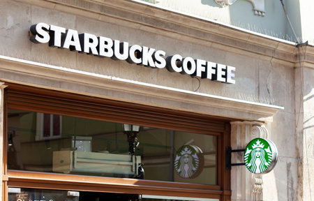 Starbucks Coffee shop signboard, store front, exterior logo sign, brand symbol signage closeup, nobody, facade Florianska street, Cracow Old Town urban areaのeditorial素材