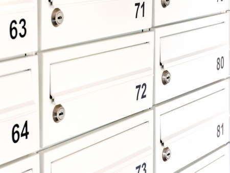 White private mailbox, letterbox detail, object closeup. Simple locked mail box, letter box up close. Modern apartment condo post message box, personal mail address, communication abstract conceptの写真素材