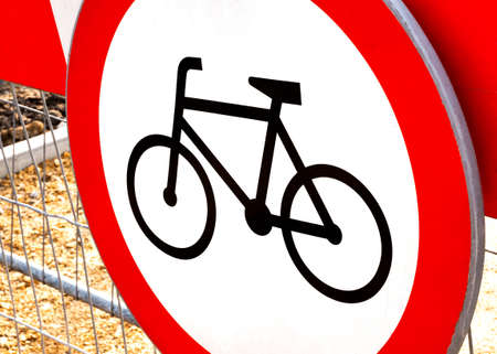 No bikes allowed, round red warning biking prohibition sign, simple symbol object detail, closeup, nobody. No bicycles, bikers, cyclists allowed in the area, no cycles, cycling disallowed conceptの写真素材