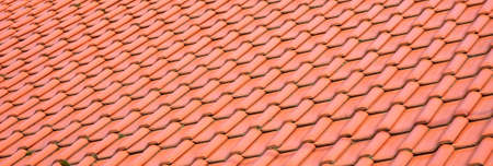 Light orange classic roof tiles, new roof covering, traditional roofing service concept. Simple wide clean banner, roof surface material abstract background texture, backdrop, object closeup, nobodyの写真素材